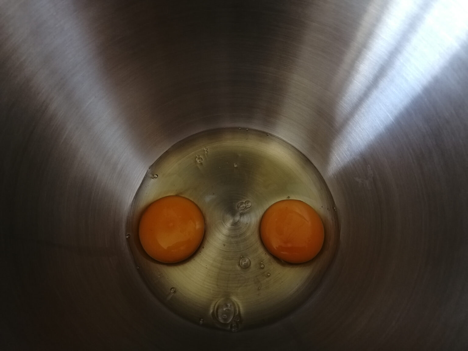 Gallery of Photography Ireland Mass Isolation Image 1 (Photo Museum Ireland) Two eggs in a stainless steel bowl as I am reduced to my least successful activity of baking to occupy my time in lockdown.